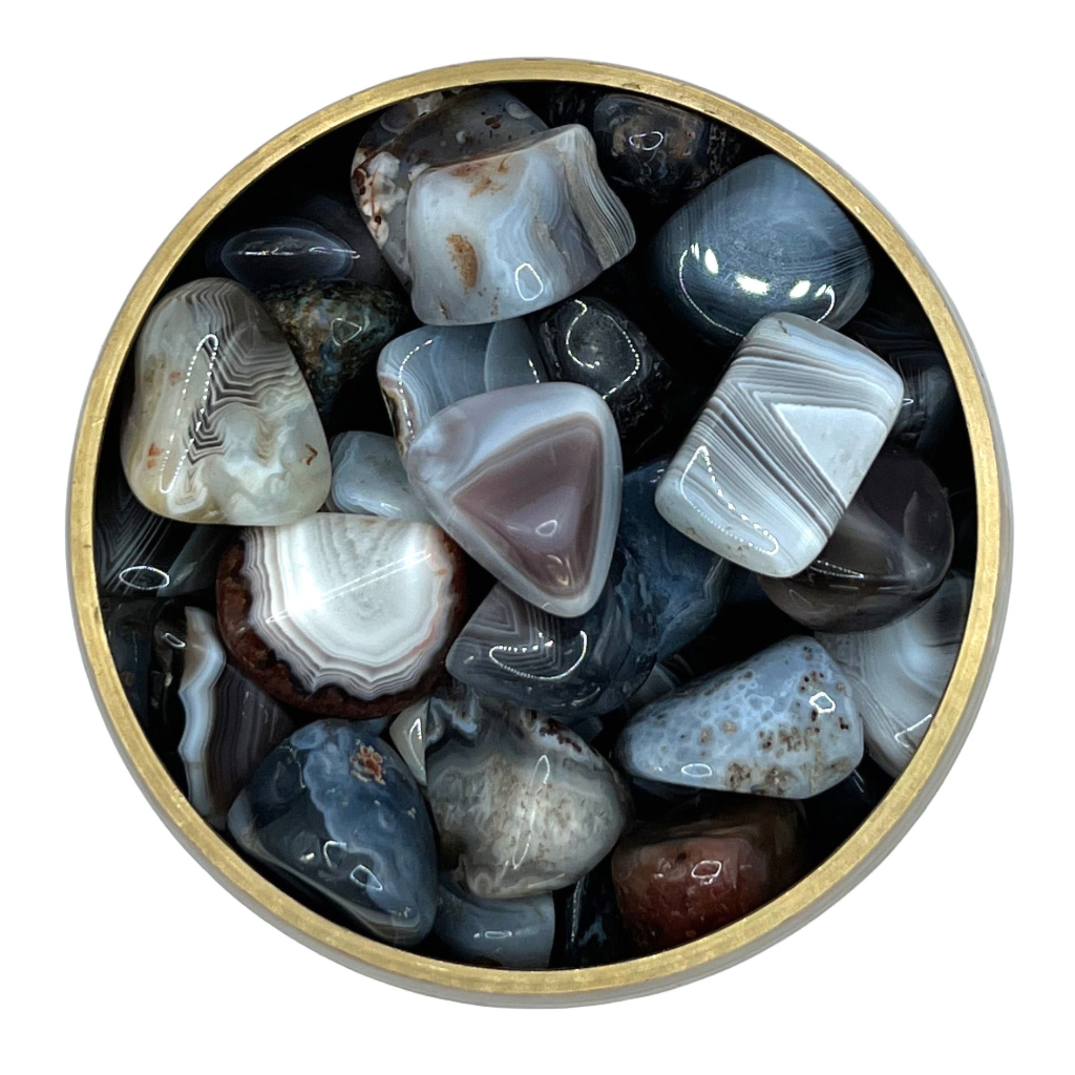 Botswana Agate tumbled stones in a round container, promoting creativity, problem-solving, and aiding in smoking cessation.
