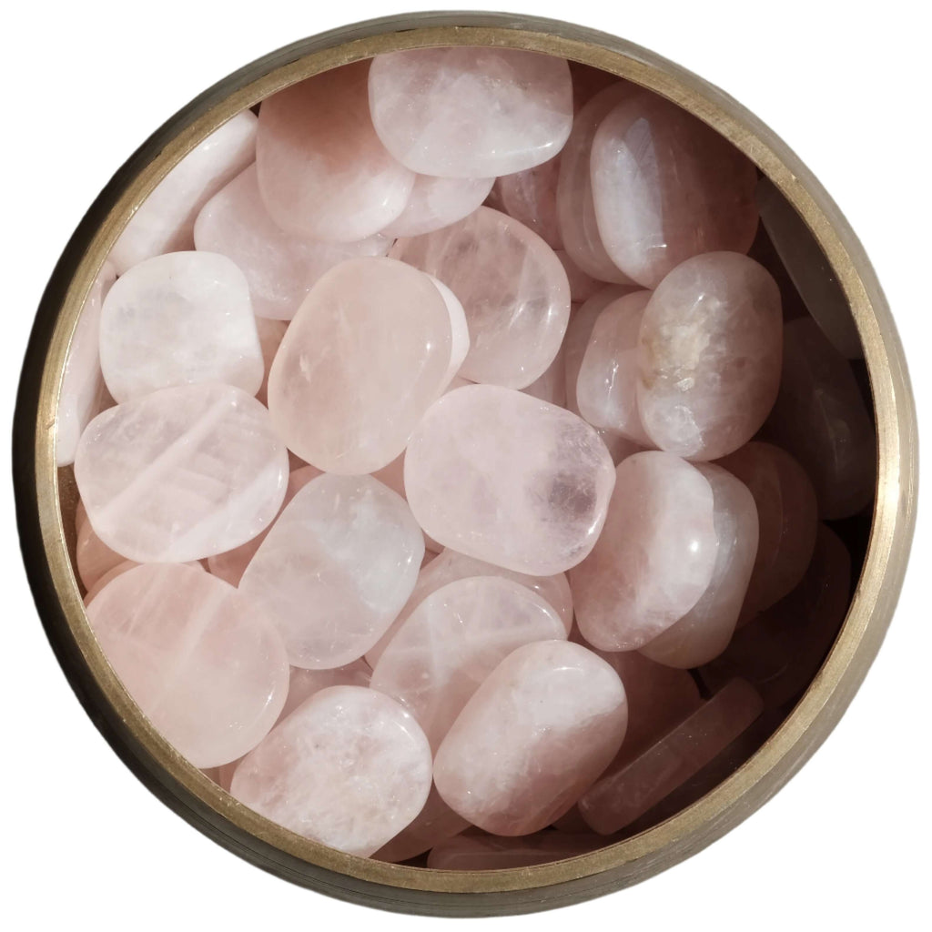 Bowl of rose quartz tumbled flat stones for self love and healing, strengthening the heart, and promoting positive self acceptance.