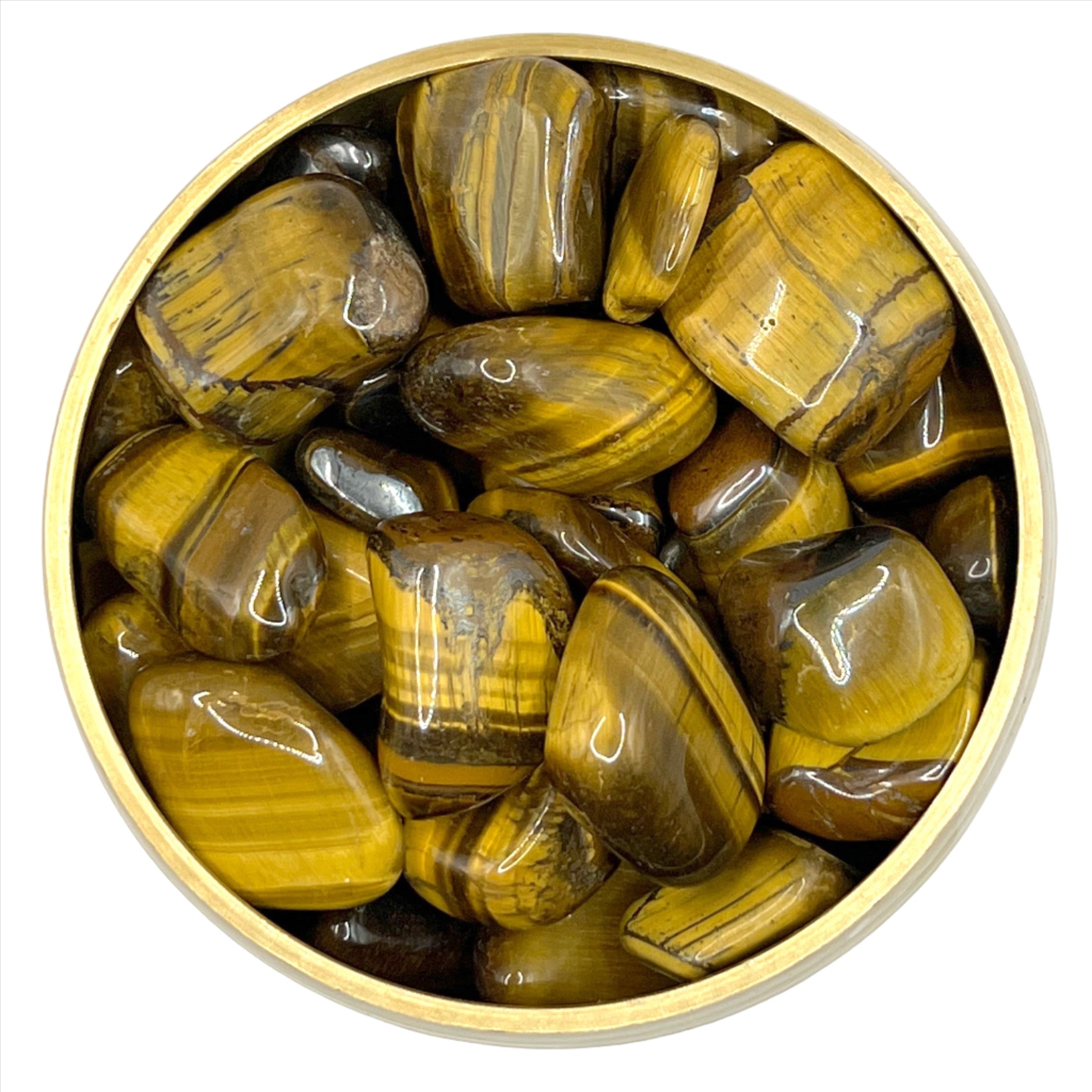 Golden brown Tiger Eye tumbled stones in a bowl, believed to aid eye health and improve circulation and flexibility.
